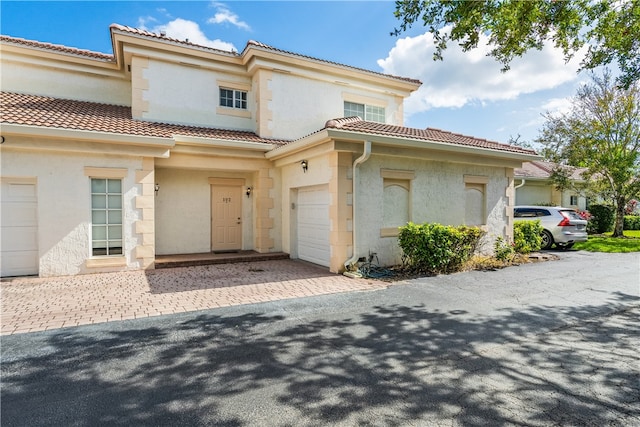 mediterranean / spanish home with a garage