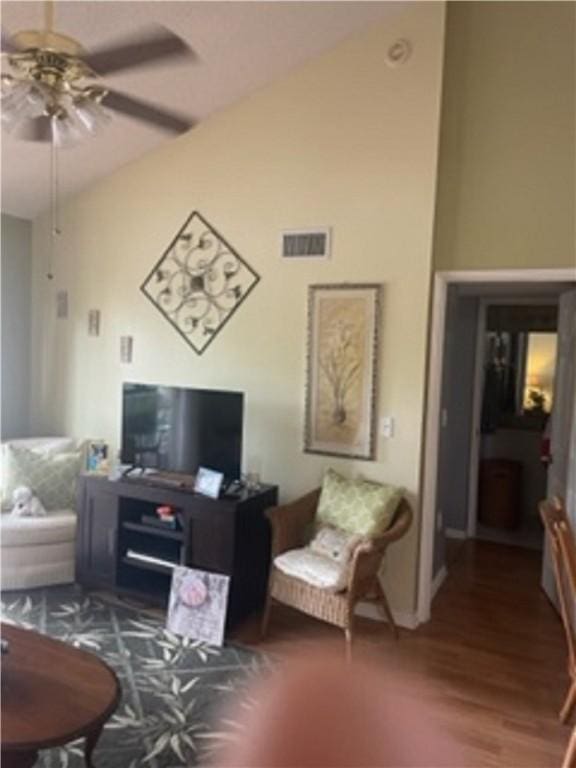 living room with dark hardwood / wood-style flooring and ceiling fan