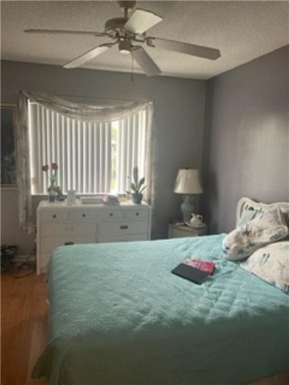 bedroom with hardwood / wood-style flooring and ceiling fan