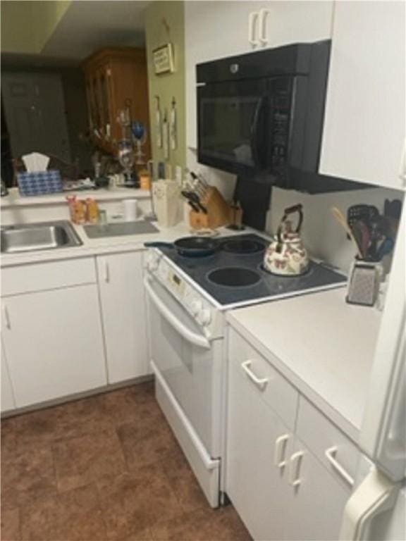 kitchen with white cabinets and white electric range