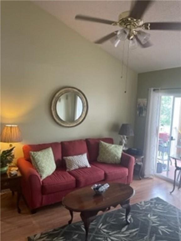 living room featuring hardwood / wood-style floors, ceiling fan, and lofted ceiling