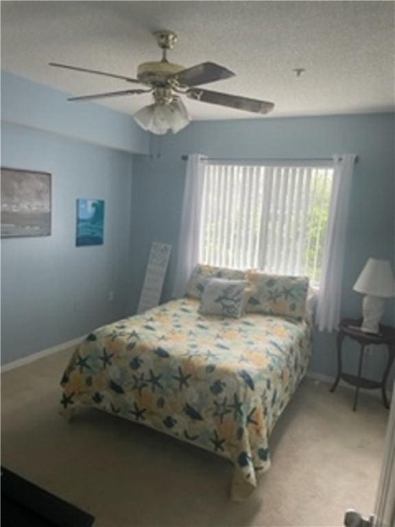 bedroom featuring ceiling fan and carpet