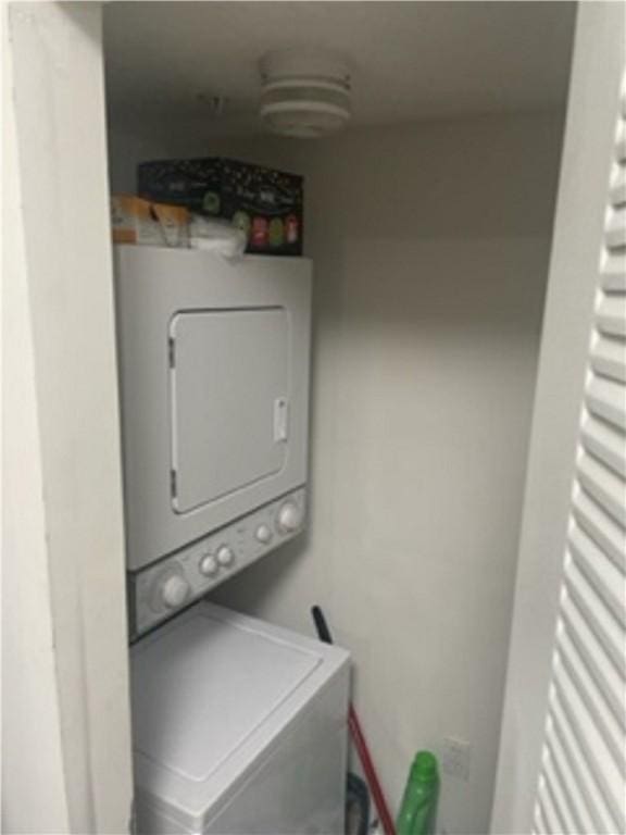 laundry room featuring stacked washing maching and dryer