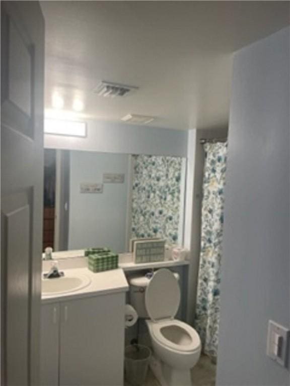 bathroom featuring vanity and toilet