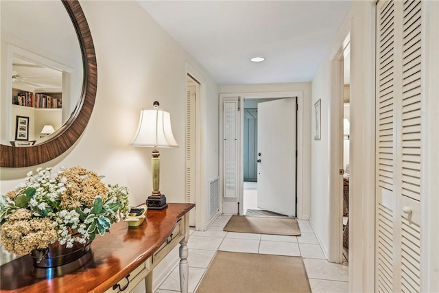 hall with light tile patterned floors