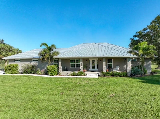 view of front of home with a front yard and french doors