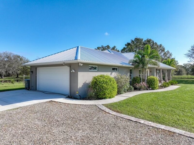 view of side of home featuring a garage and a lawn