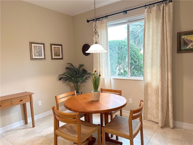 tiled dining area featuring a healthy amount of sunlight