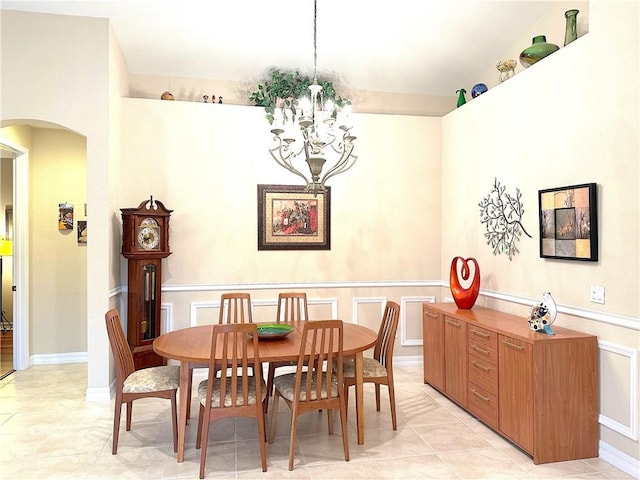 tiled dining room featuring a notable chandelier