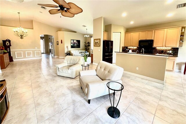 dining space featuring french doors, ceiling fan with notable chandelier, and light tile patterned floors