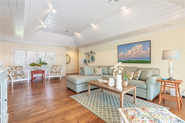 living area with visible vents, hardwood / wood-style flooring, wooden ceiling, crown molding, and lofted ceiling