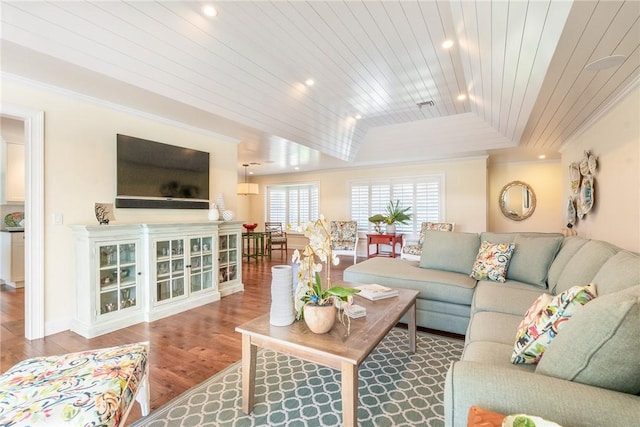 living area with baseboards, ornamental molding, recessed lighting, wooden ceiling, and wood finished floors