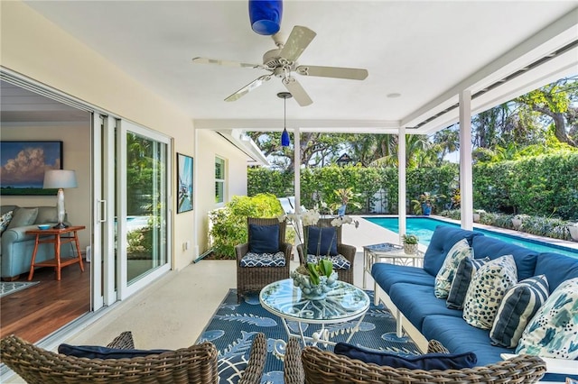 sunroom / solarium featuring a ceiling fan