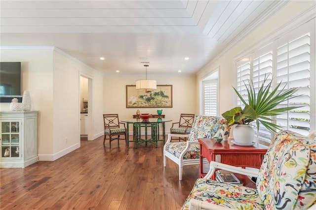 living area with hardwood / wood-style floors, crown molding, recessed lighting, and baseboards