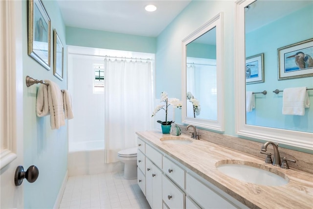 full bathroom with tile patterned floors, double vanity, toilet, and a sink