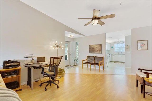 office area featuring sink, light hardwood / wood-style floors, and vaulted ceiling