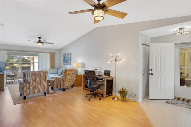 office space featuring ceiling fan, light hardwood / wood-style floors, and vaulted ceiling