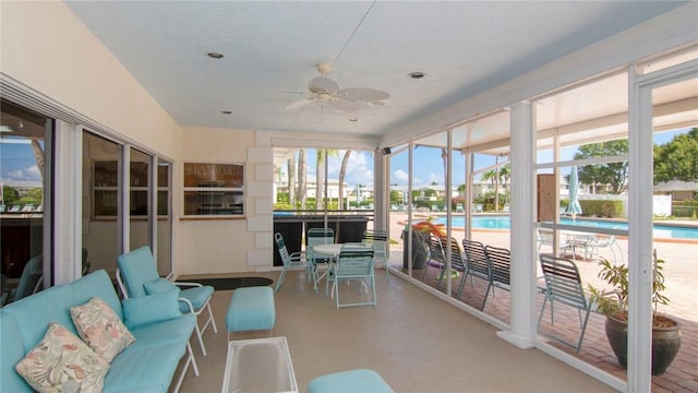 sunroom with ceiling fan and plenty of natural light