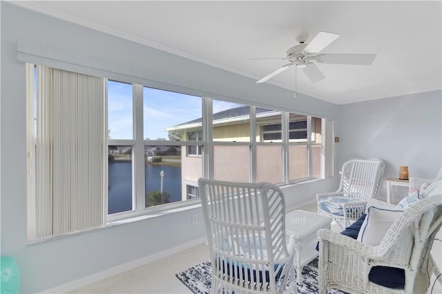 sunroom with a water view and ceiling fan