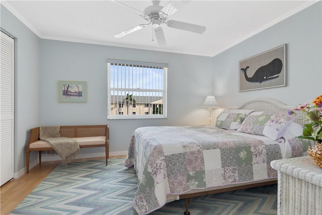 bedroom featuring hardwood / wood-style flooring, ceiling fan, and crown molding