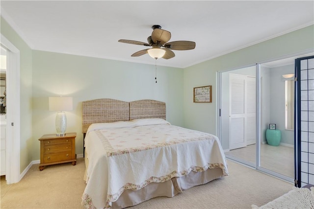 bedroom featuring light carpet, a closet, ceiling fan, and crown molding