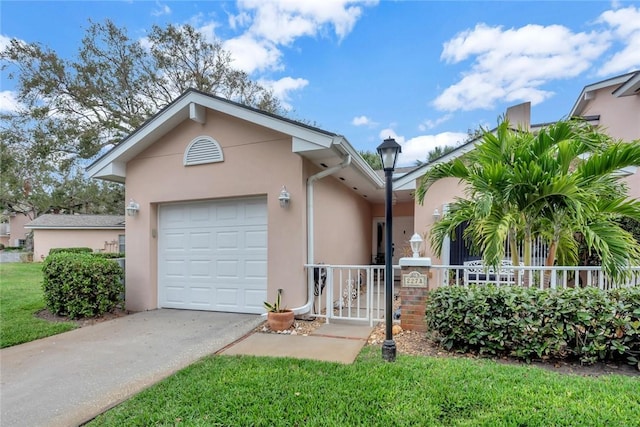 single story home with a garage, driveway, fence, and stucco siding