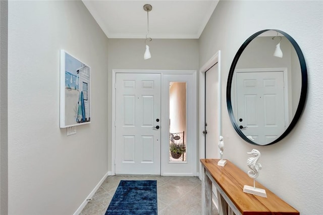 foyer featuring ornamental molding, baseboards, and light tile patterned floors