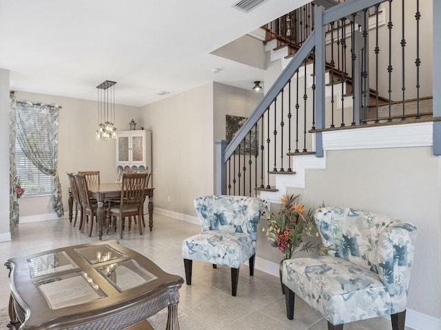 living room featuring light tile patterned floors and an inviting chandelier