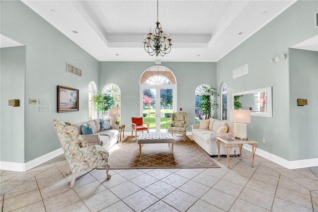 living area with light tile patterned floors, a raised ceiling, and visible vents