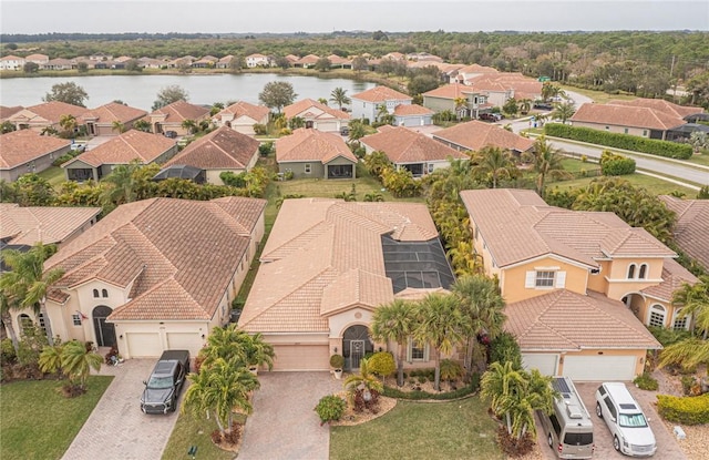 birds eye view of property featuring a water view and a residential view