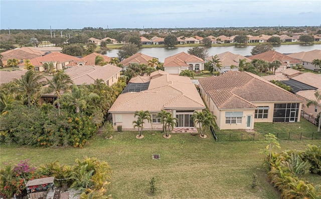 drone / aerial view with a water view and a residential view