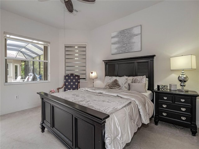 bedroom with light carpet, baseboards, and a ceiling fan