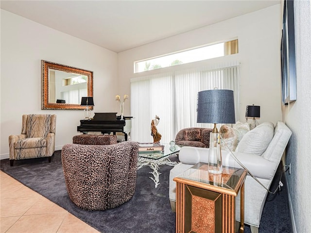 carpeted living area featuring tile patterned flooring and baseboards