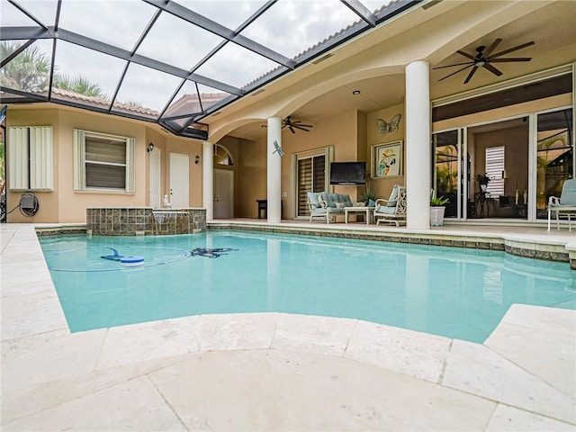 pool featuring ceiling fan, a patio, outdoor lounge area, and glass enclosure