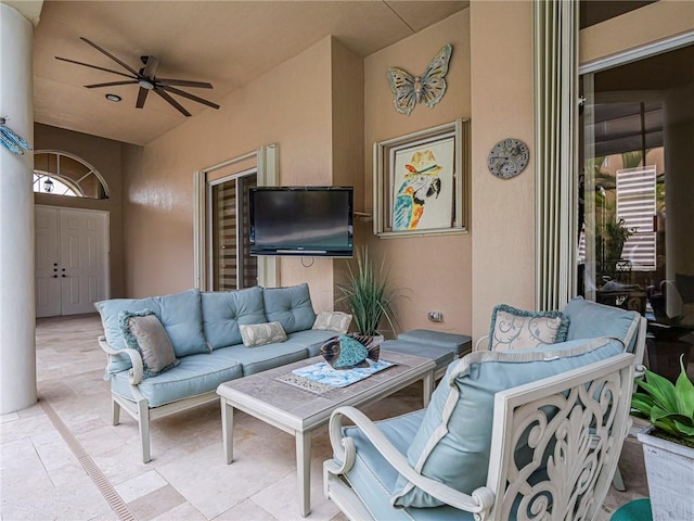 view of patio with ceiling fan and an outdoor living space