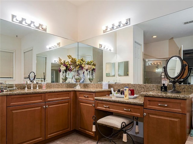 full bathroom featuring a stall shower, tile patterned flooring, visible vents, and vanity