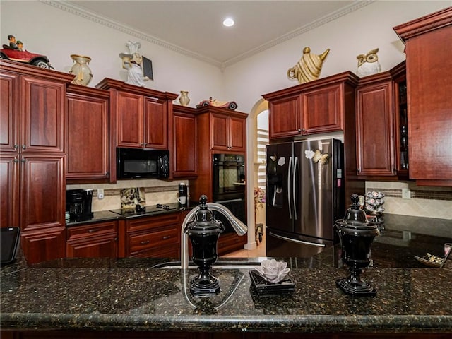 kitchen with reddish brown cabinets, black appliances, backsplash, and arched walkways