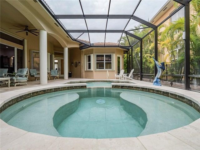 view of pool featuring a patio area, ceiling fan, and glass enclosure