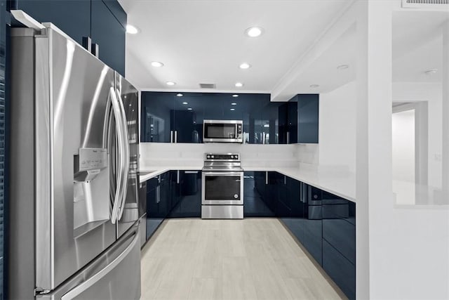 924 Coquina Ln Unit 3, Vero Beach, FL 32963 - kitchen with appliances with stainless steel finishes, modern cabinets, recessed lighting, light countertops, and dark cabinets