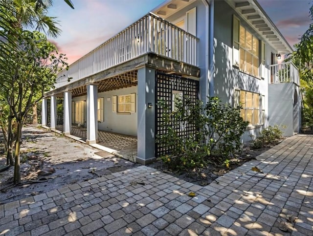924 Coquina Ln Unit 3, Vero Beach, FL 32963 - view of side of property featuring stucco siding, a patio, and a balcony