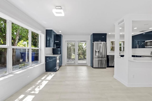924 Coquina Ln Unit 3, Vero Beach, FL 32963 - kitchen with stainless steel appliances, blue cabinets, light countertops, recessed lighting, and dark cabinets