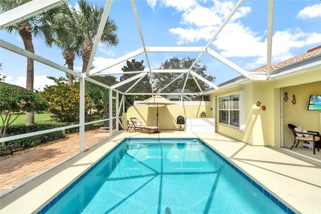 outdoor pool with a patio area and a lanai