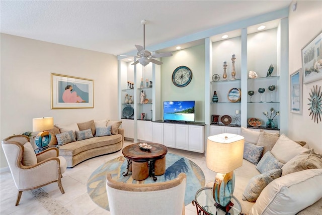 living room with built in shelves, ceiling fan, and recessed lighting