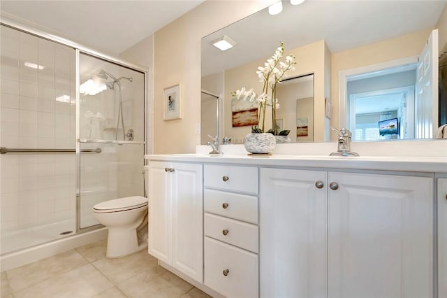 bathroom with tile patterned flooring, a stall shower, double vanity, and toilet