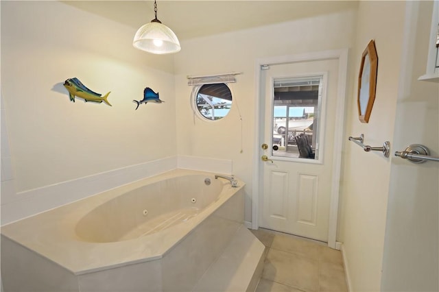 bathroom with tile patterned flooring and a tub to relax in