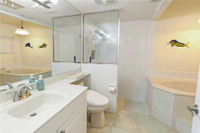 full bathroom with shower with separate bathtub, tile walls, tile patterned flooring, vanity, and toilet