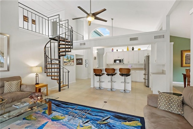 tiled living room with high vaulted ceiling and ceiling fan