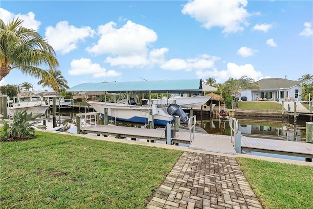 view of dock with a water view and a lawn