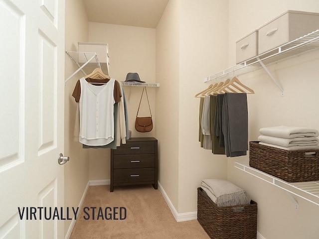 spacious closet featuring light carpet