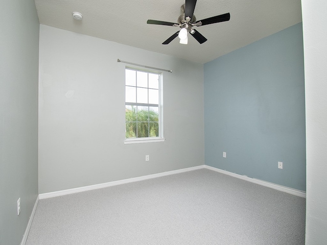 spare room featuring ceiling fan, a textured ceiling, and carpet flooring